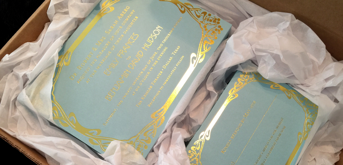 fingerprint design's photo of Emily's gold foil invitation suite, all packaged for delivery to the bride